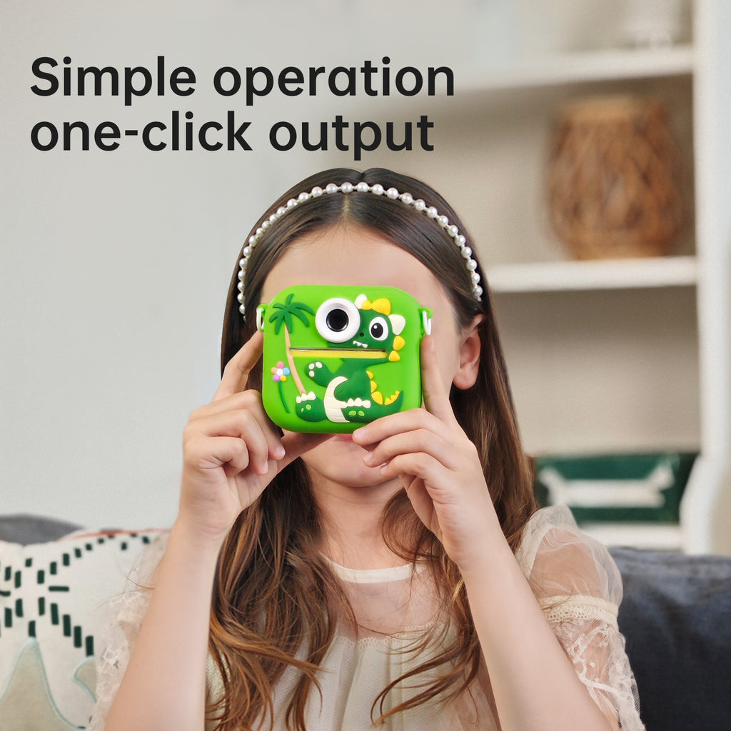 A child wearing a pearl headband holds a bright green monster-shaped phone case in front of their face. The case has cartoon eyes, a smiling mouth, and tropical leaf details.
